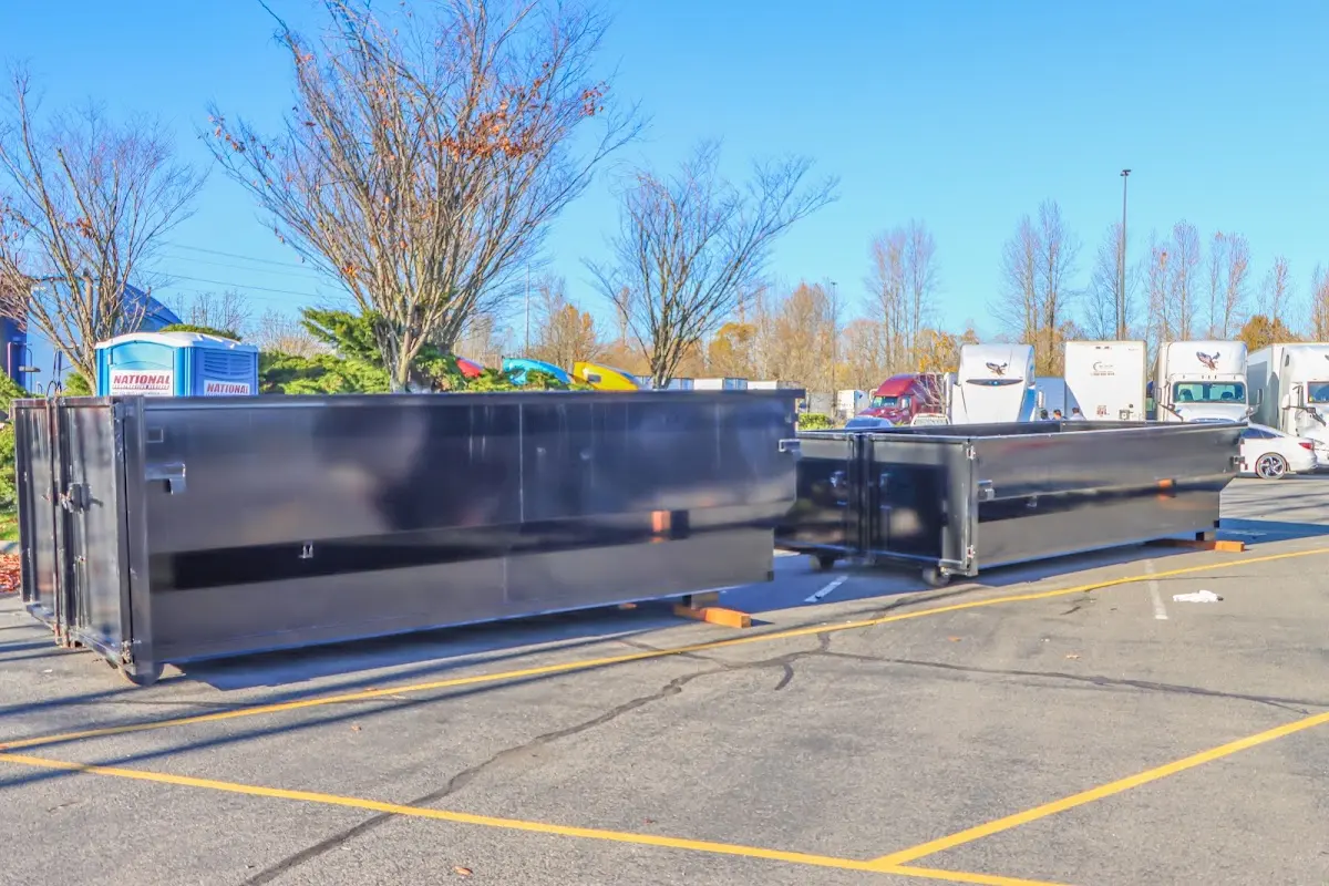 Professional dumpster rental service with roll-off container on residential driveway in Beech Grove